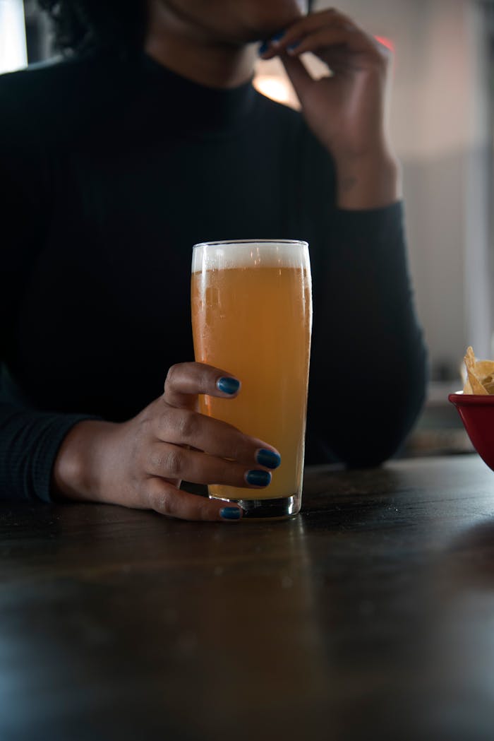 Person Holding Drinking Glass With Beer